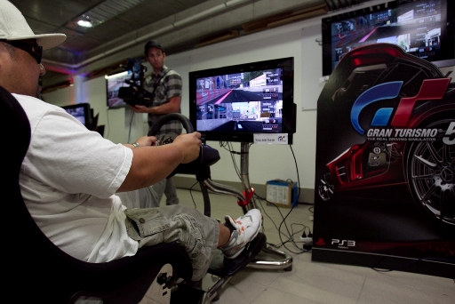 A competitor 'racing' with Gran Turismo 5 on the VisionRacer system